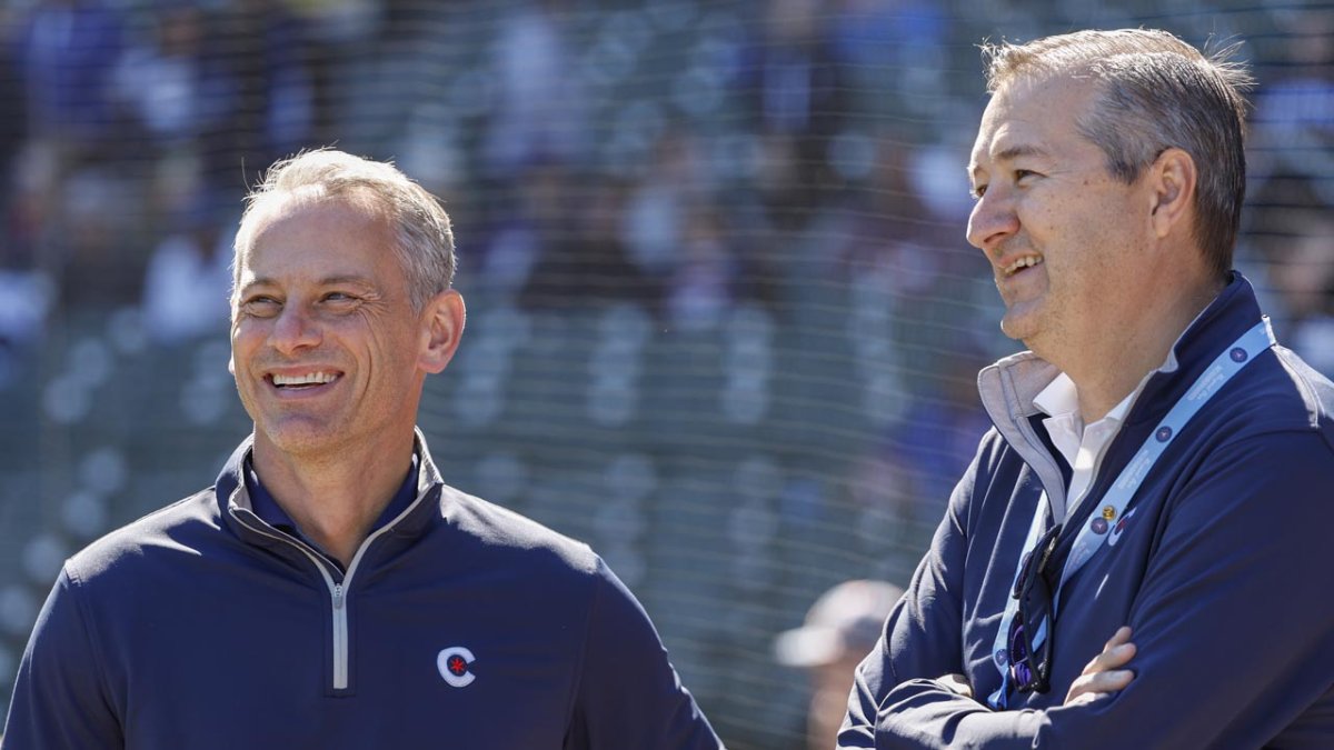 President Jed Hoyer of the Chicago Cubs presents a jersey to