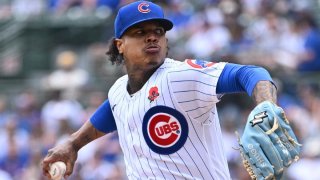 Marcus Stroman, wearing a Cubs white and blue uniform with a blue glove and a blue hat, throws a pitch on Memorial Day against Tampa Bay.