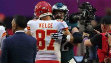 Jason Kelce devours a chocolate bar while his rival brother scores