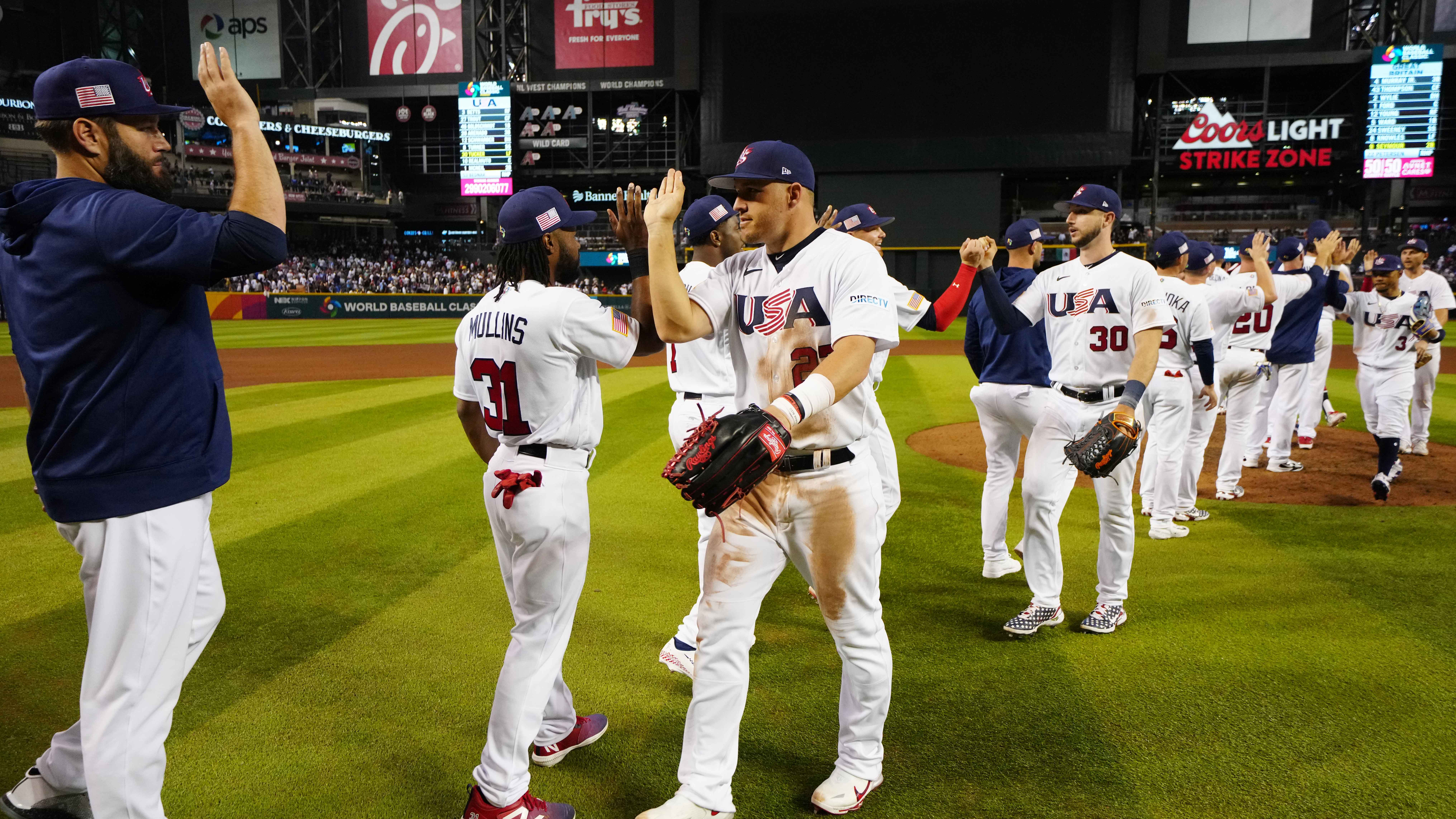 Manager Mark DeRosa stands with J.T. Realmuto during the Team USA