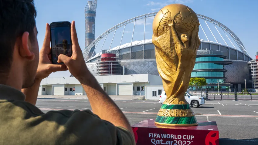 Person taking picture of FIFA World Cup trophy statue