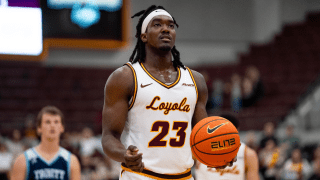 Loyola basketball player Philip Alston holds the ball before a free throw