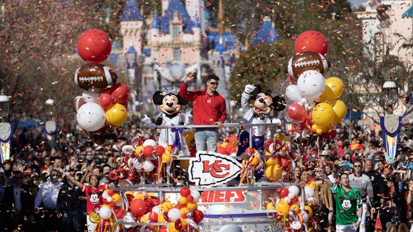 Patrick Mahomes of the Kansas City Chiefs celebrates his team’s Super Bowl triumph with a victory parade down Main Street, U.S.A., alongside Mickey Mouse and Minnie Mouse at Disneyland Park on February 13, 2023, in Anaheim, California.