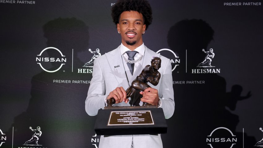 Dec 9, 2023; New York, New York, USA; LSU Tigers quarterback Jayden Daniels poses for photos with the Heisman trophy during a press conference in the Astor ballroom at the New York Marriott Marquis after winning the Heisman trophy. Mandatory Credit: Brad Penner-USA TODAY Sports