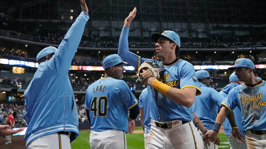 May 31, 2024; Milwaukee, Wisconsin, USA;  Milwaukee Brewers left fielder Christian Yelich (22) high fives teammates following the game against the Chicago White Sox at American Family Field. Mandatory Credit: Jeff Hanisch-USA TODAY Sports