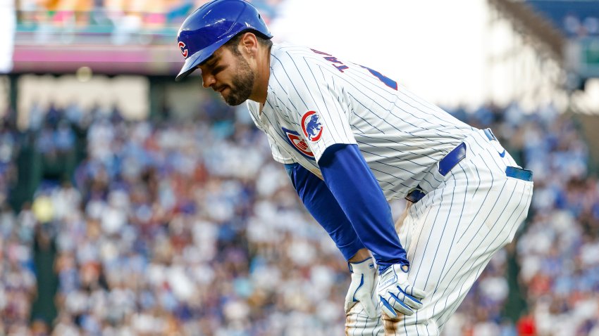 Jun 17, 2024; Chicago, Illinois, USA; Chicago Cubs outfielder Mike Tauchman (40) reacts after injuring his leg after running to first base after hitting a single against the San Francisco Giants during the third inning at Wrigley Field. Mandatory Credit: Kamil Krzaczynski-USA TODAY Sports