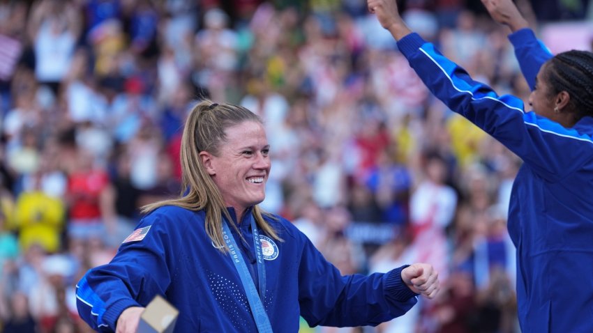 Alyssa Naeher celebrates with gold medal