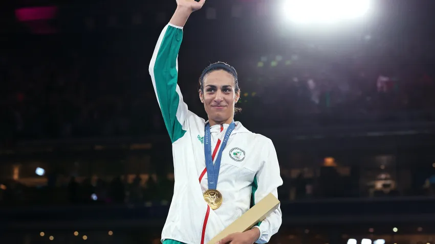 PARIS, FRANCE – AUGUST 09: Gold Medallist Imane Khelif of Team Algeria acknowledges the crowd from the podium during the Boxing Women’s 66kg medal ceremony after the Boxing Women’s 66kg Final match on day fourteen of the Olympic Games Paris 2024 at Roland Garros on August 09, 2024 in Paris, France. (Photo by Richard Pelham/Getty Images)