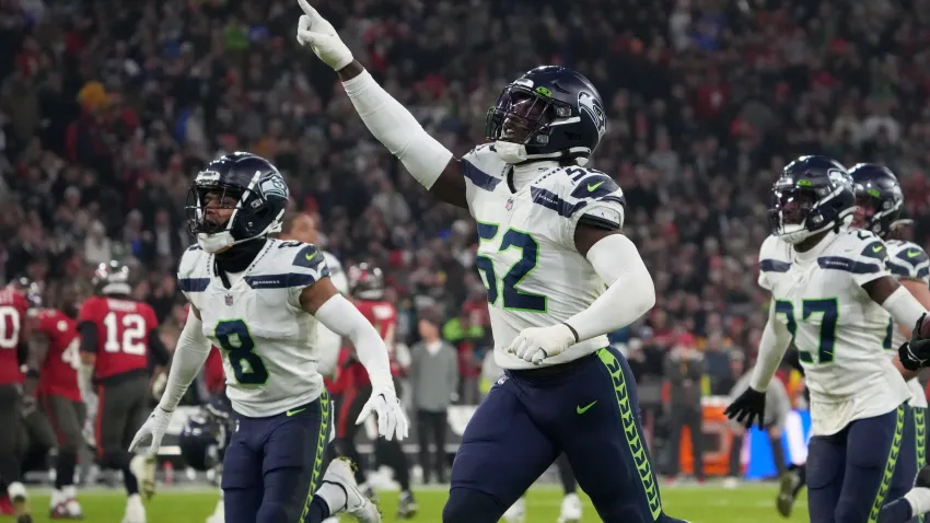 Nov 13, 2022; Munich, Germany; Seattle Seahawks cornerback Coby Bryant (8) and defensive end Darrell Taylor (52) celebrate after an interception in the second half against the Tampa Bay Buccaneers during an NFL International Series game at Allianz Arena. Mandatory Credit: Kirby Lee-USA TODAY Sports