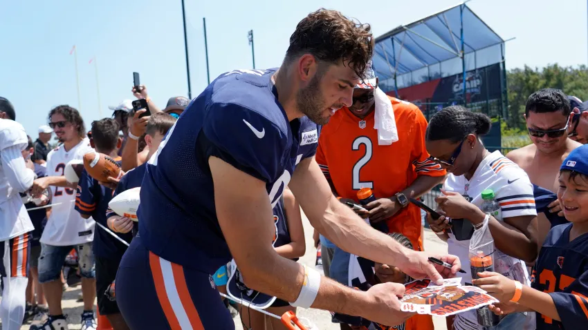 Jul 27, 2024; Lake Forest, IL, USA; Chicago Bears tight end Cole Kmet (85) signs autographs during Chicago Bears Training Camp at Halas Hall. Mandatory Credit: David Banks-USA TODAY Sports