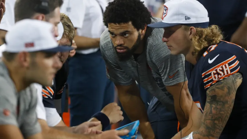 Aug 1, 2024; Canton, Ohio, USA;  Chicago Bears quarterback Caleb Williams (RC) listens in the quarterback huddle on he sidelines against the Houston Texans during the third quarter at Tom Benson Hall of Fame Stadium. Mandatory Credit: Charles LeClaire-USA TODAY Sports