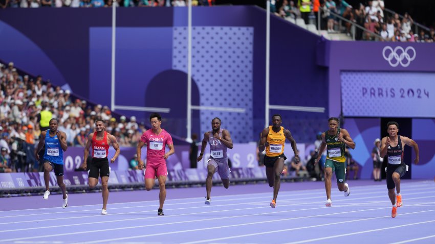 Louie Hinchliffe wins a men's 100m round 1 heat ahead of Noah Lyles