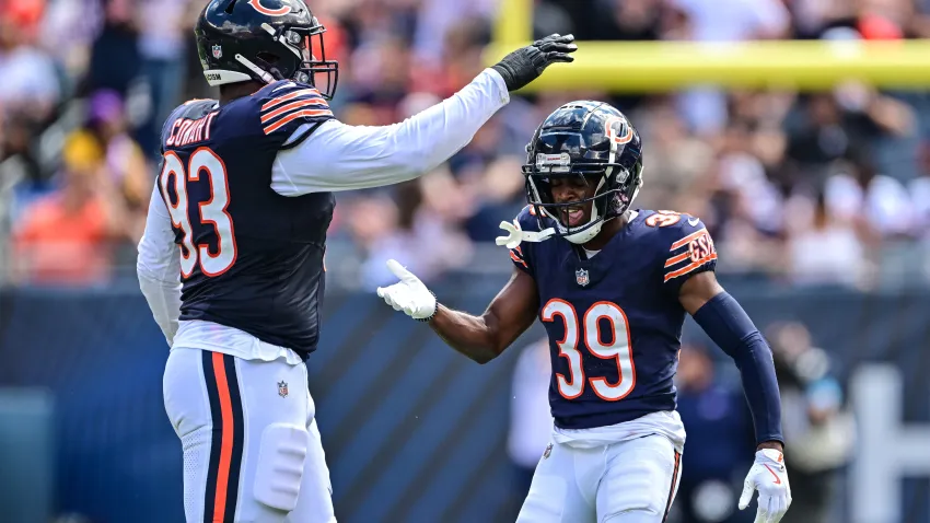 Aug 17, 2024; Chicago, Illinois, USA; Chicago Bears defensive tackle Byron Cowart (93) and cornerback Josh Blackwell (39) celebrate a defensive stop against the Cincinnati Bengals during the second quarter at Soldier Field. Mandatory Credit: Daniel Bartel-USA TODAY Sports