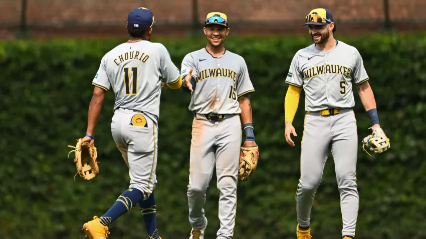 CHICAGO, ILLINOIS – JULY 24: Jackson Chourio #11, Blake Perkins #16, and Garrett Mitchell #5 of the Milwaukee Brewers celebrate the 3-2 win against the Chicago Cubs at Wrigley Field on July 24, 2024 in Chicago, Illinois. (Photo by Quinn Harris/Getty Images)