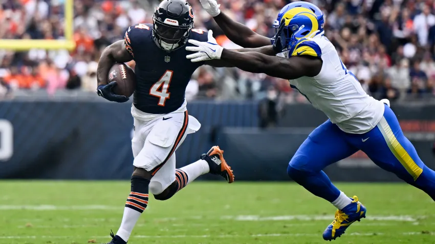 CHICAGO, ILLINOIS – SEPTEMBER 29: D’Andre Swift #4 of the Chicago Bears carries the ball past Byron Young #0 of the Los Angeles Rams during the third quarter at Soldier Field on September 29, 2024 in Chicago, Illinois. (Photo by Quinn Harris/Getty Images)