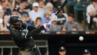 Jul 28, 2024; Chicago, Illinois, USA; Chicago White Sox outfielder Luis Robert Jr. (88) doubles against the Kansas City Royals during the third inning at Guaranteed Rate Field. Mandatory Credit: Kamil Krzaczynski-USA TODAY Sports