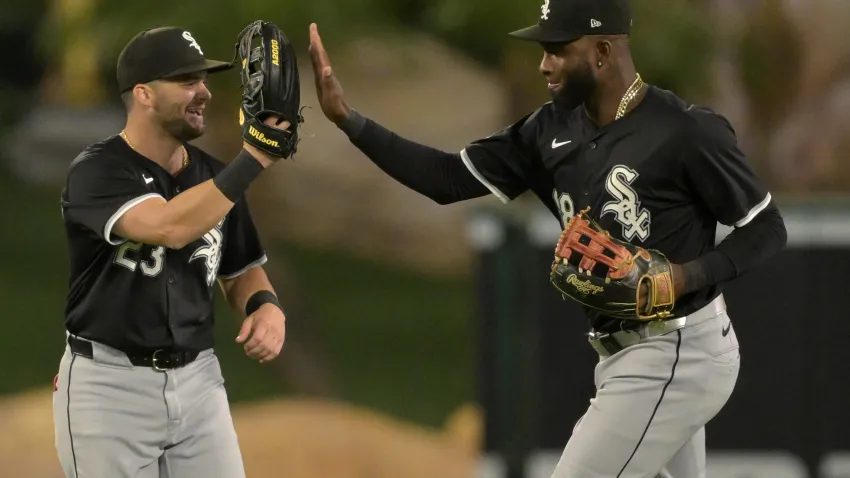 Sep 16, 2024; Anaheim, California, USA; Chicago White Sox left fielder Andrew Benintendi (23) and Chicago White Sox center fielder Luis Robert Jr. (88) high five after the final out of the ninth inning defeating the Los Angeles Angels at Angel Stadium. Mandatory Credit: Jayne Kamin-Oncea-Imagn Images